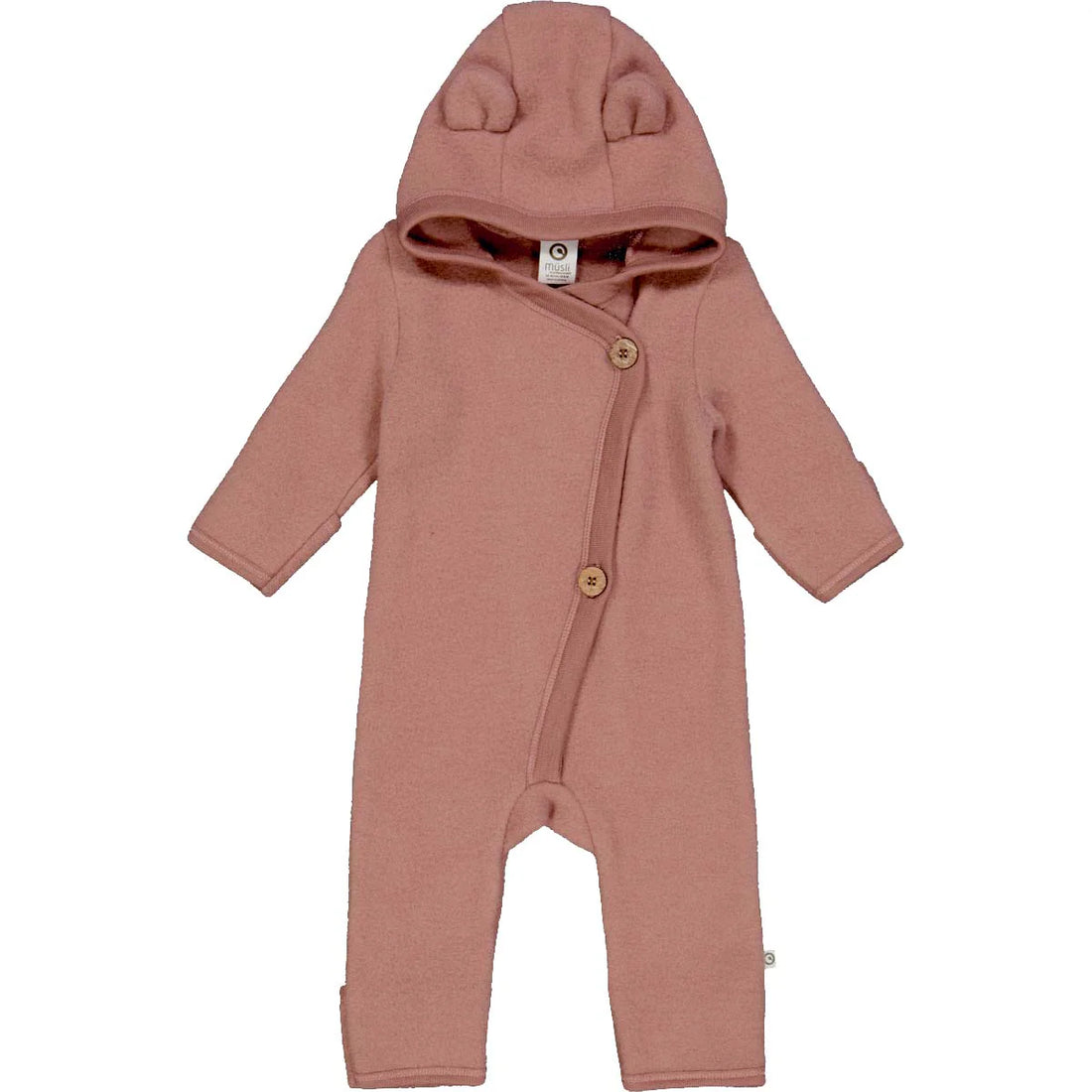 Baby fleece suit made of GOTS-certified organic merino wool, featuring a hood with ears and wooden buttons, in pink.