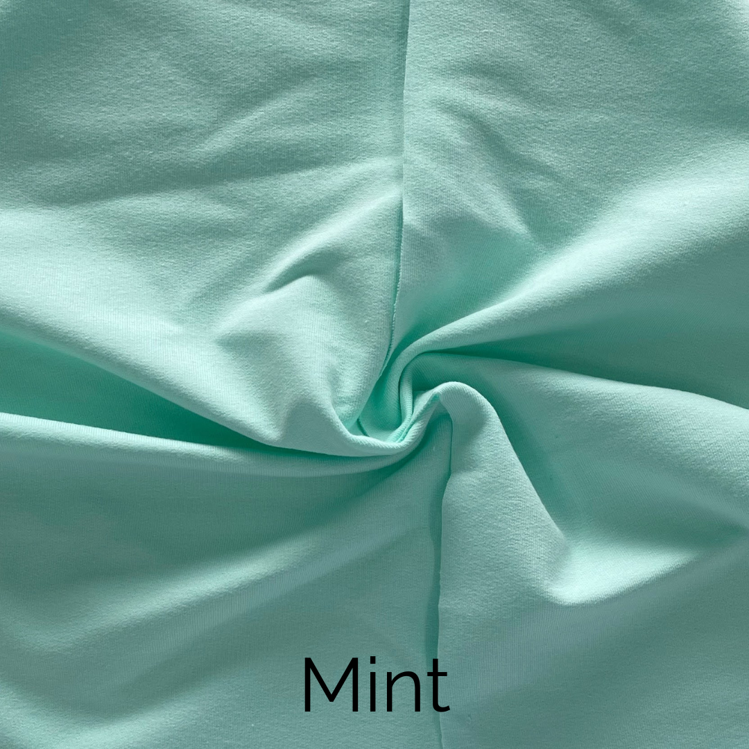 Mint colored fabric close-up showcasing soft texture, perfect for creating stylish home decor.